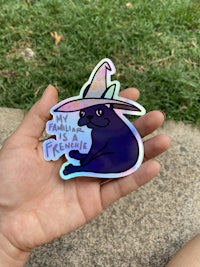 a person holding a sticker with a unicorn on it